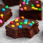 stacked chocolate brownies with colorful chocolate candy baked in.