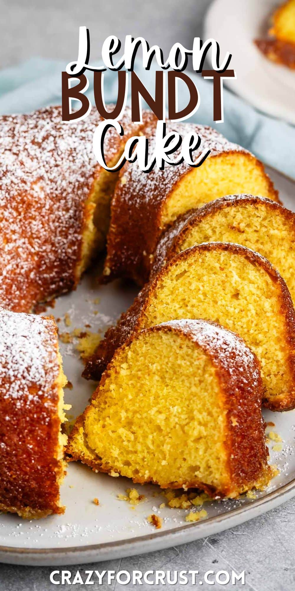 sliced bundt cake on a grey plate covered in powdered sugar with words on the image.