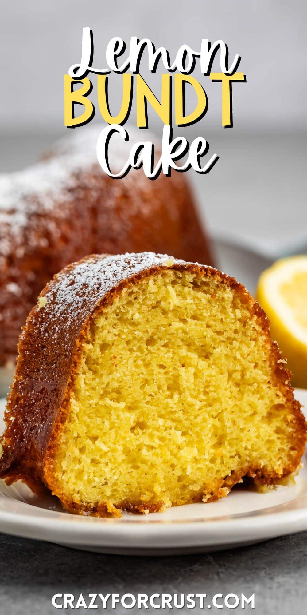 sliced bundt cake on a grey plate covered in powdered sugar with words on the image.