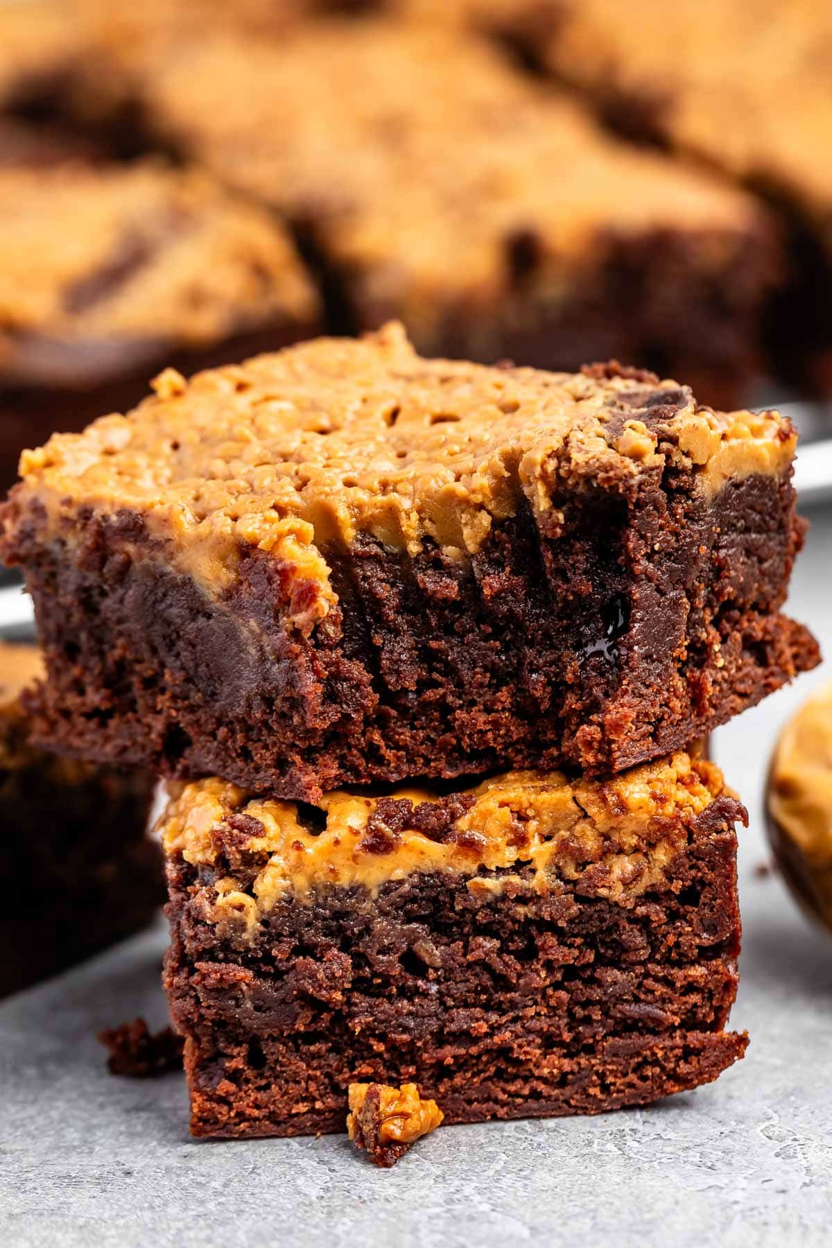 stacked brownies with peanut butter on top.