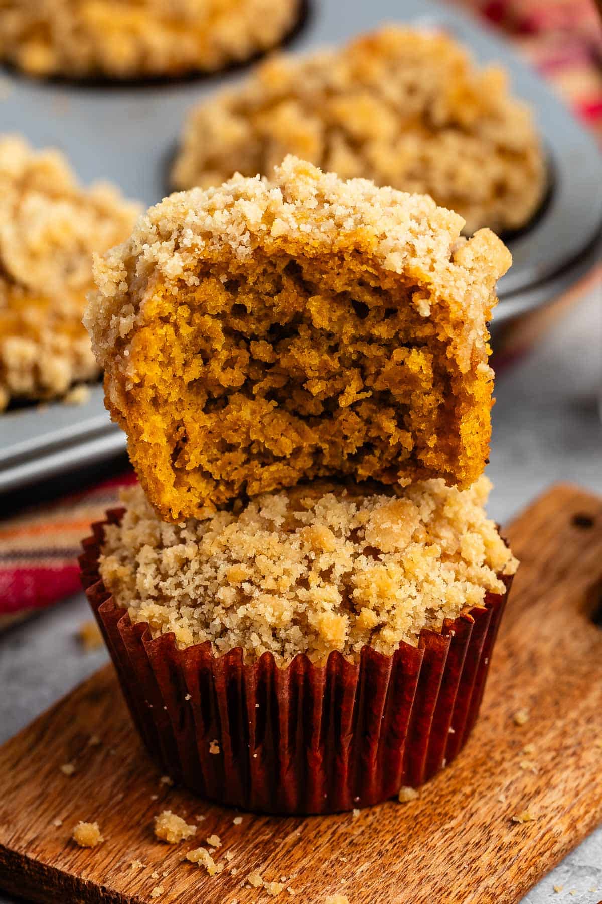 stacked muffins with streusel crumble topping.