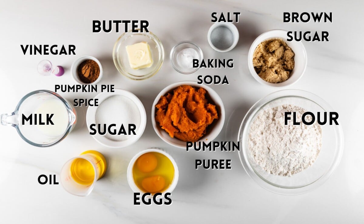 ingredients in pumpkin streusel muffins laid out on a white counter.