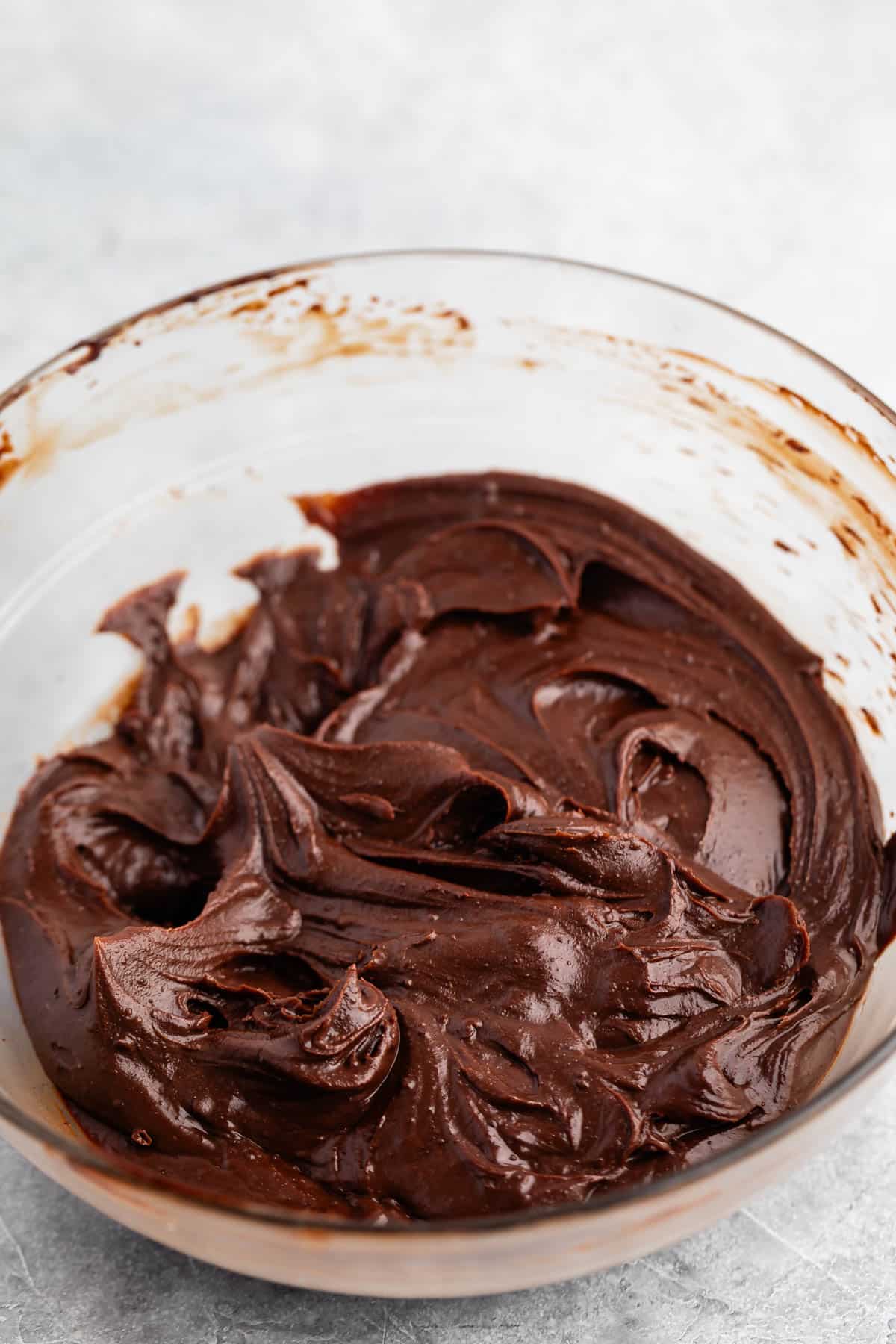 chocolate frosting in a clear bowl.