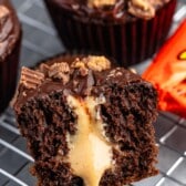 chocolate cupcake cut in half with peanut butter filling pouring out.