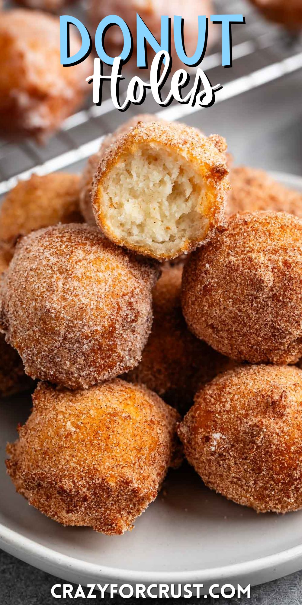 stacked donut holes on a grey plate with words on the image.