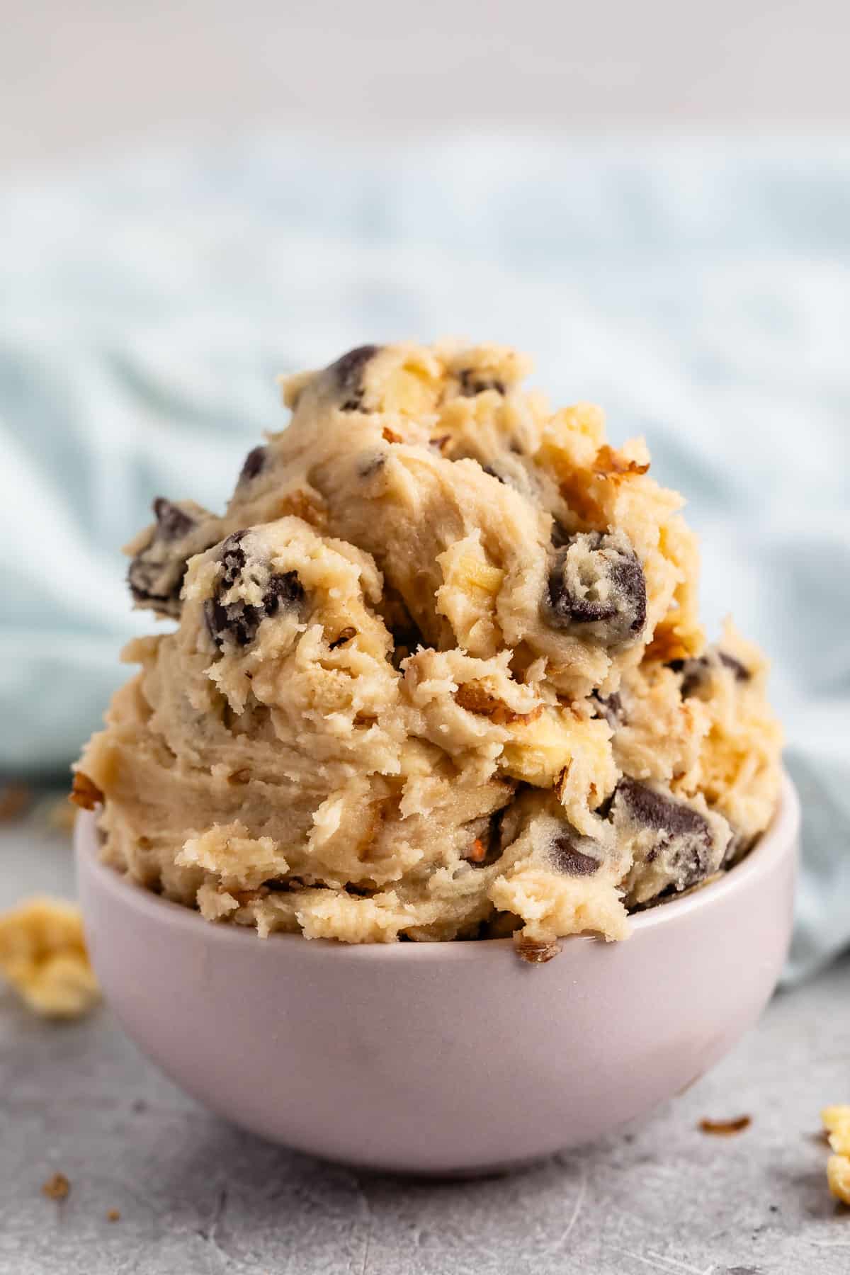 cookie dough mixed with chocolate chips in pastel colored bowls.