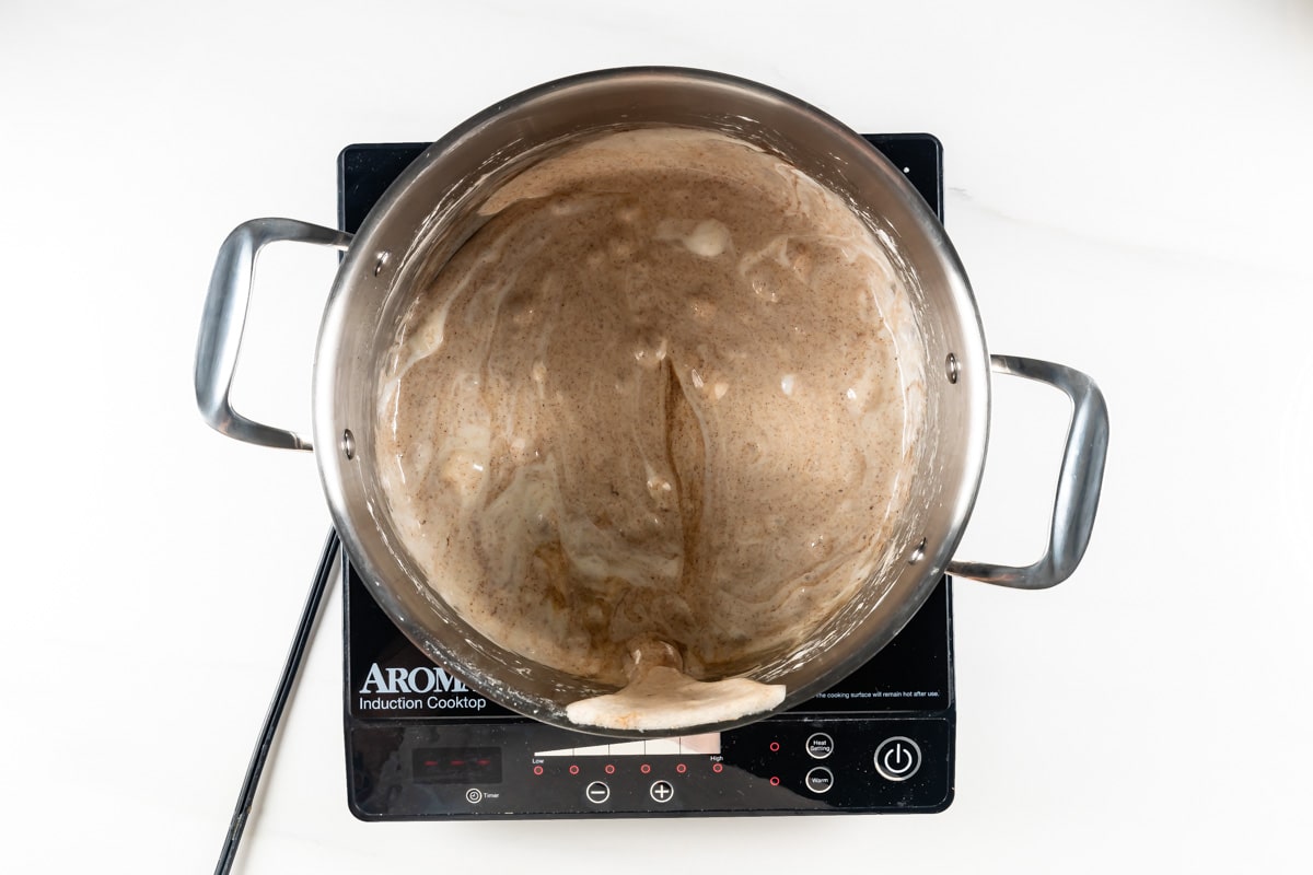 process shot of pumpkin Rice Krispie treats being made.