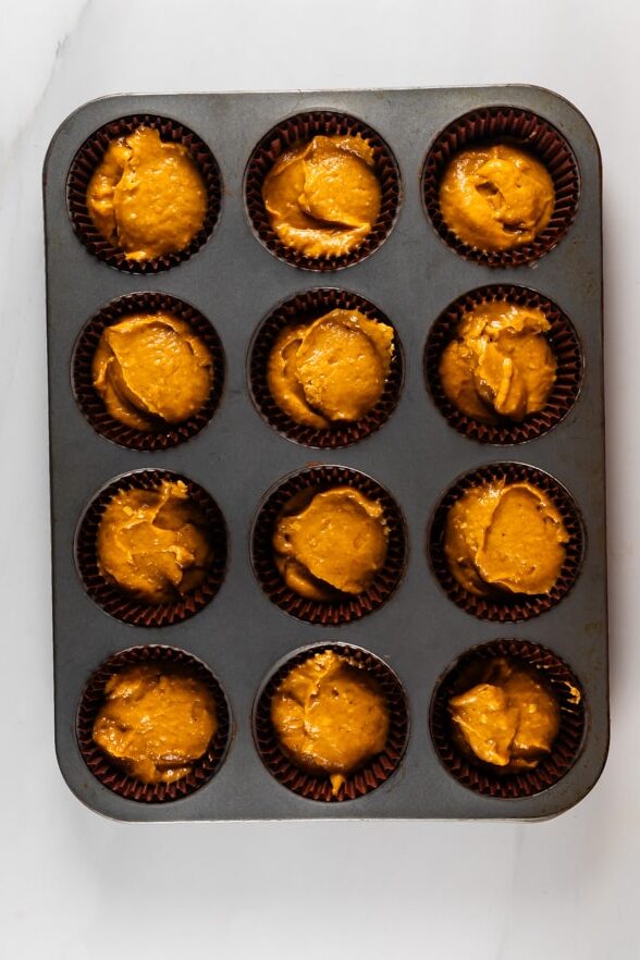 process shot of pumpkin streusel muffins being made.