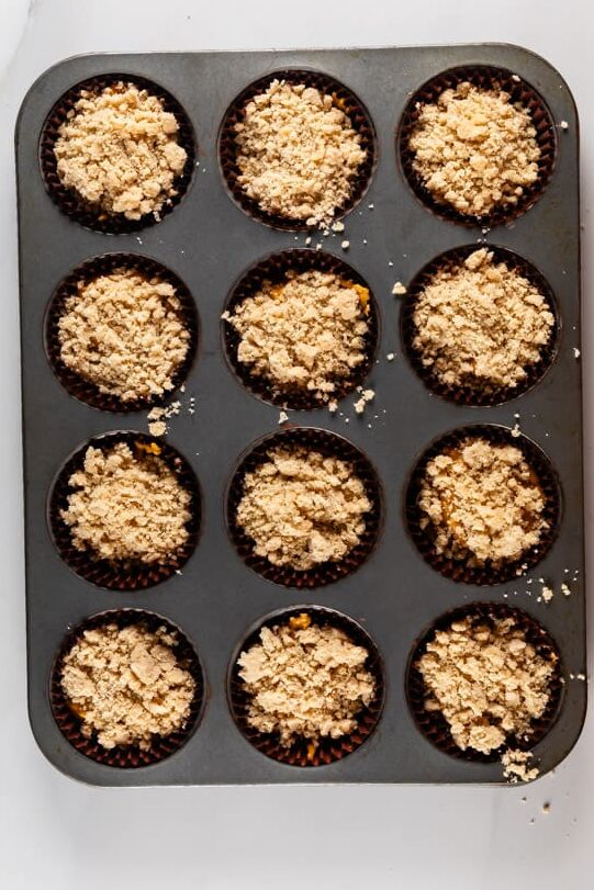 process shot of pumpkin streusel muffins being made.