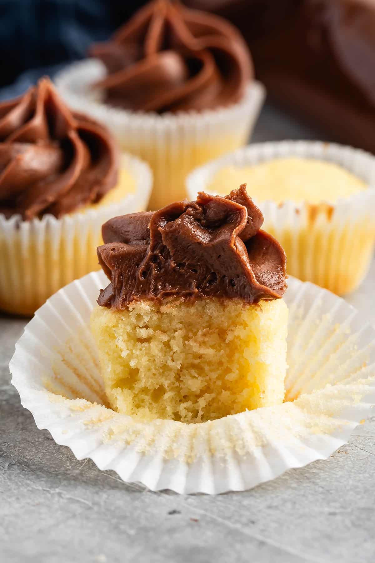 mini vanilla cupcakes with chocolate frosting.