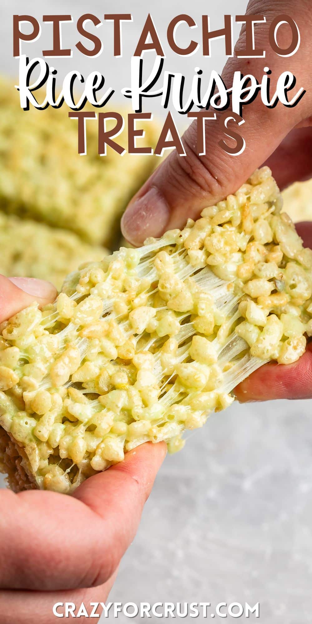 two hands pulling the pistachio Rice Krispie treats apart with words on the image.