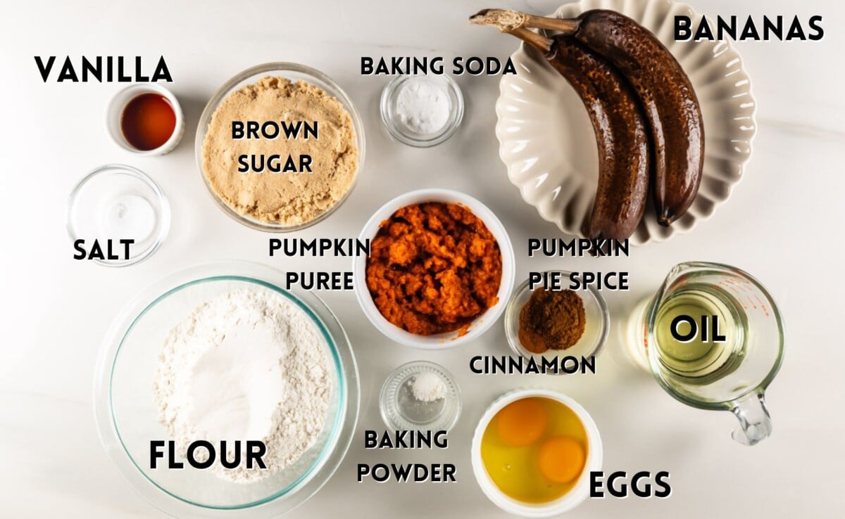 pumpkin banana bread ingredients laid out on a marble counter.