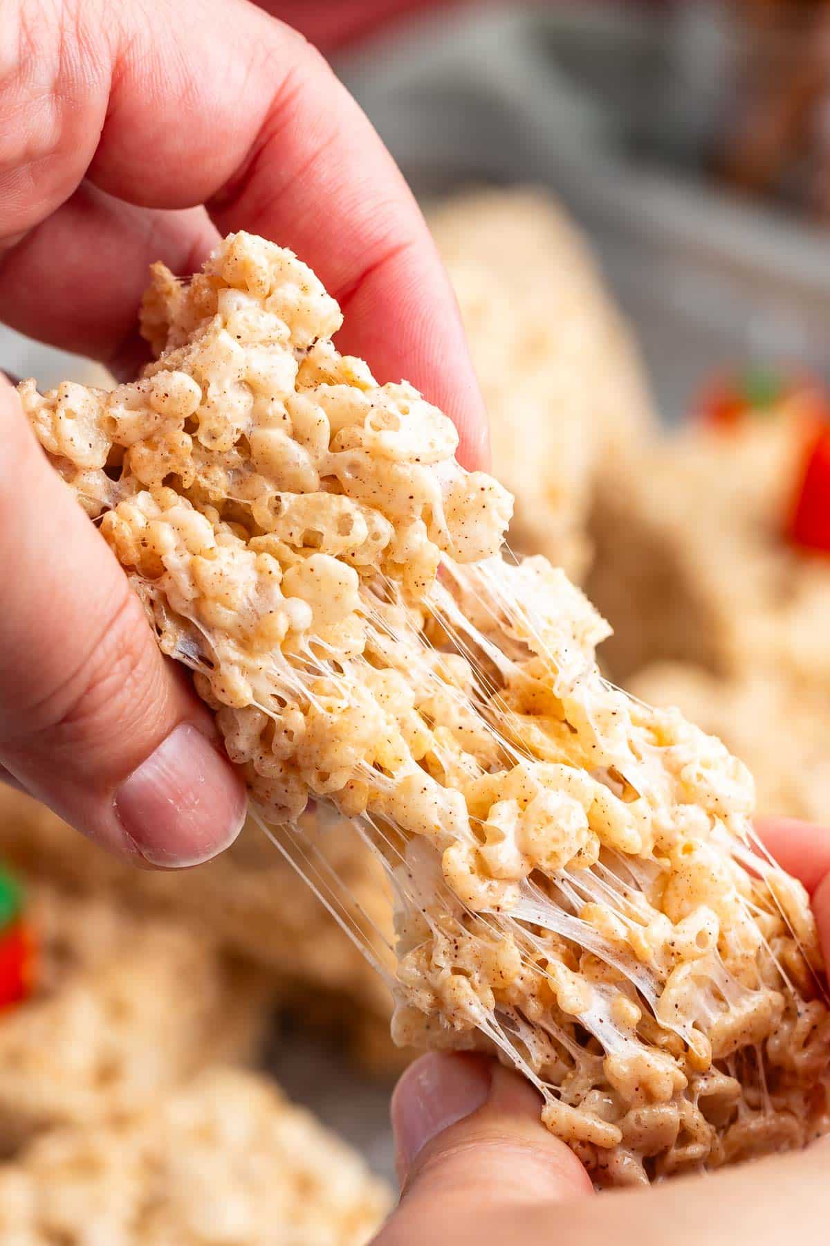 hand pulling apart pumpkin Rice Krispie treat.