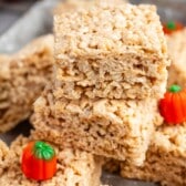 stacked Rice Krispie treats surrounded by pumpkin candy corn.