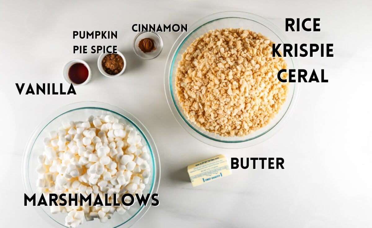 ingredients in pumpkin Rice Krispie treats laid out on a white marble counters.