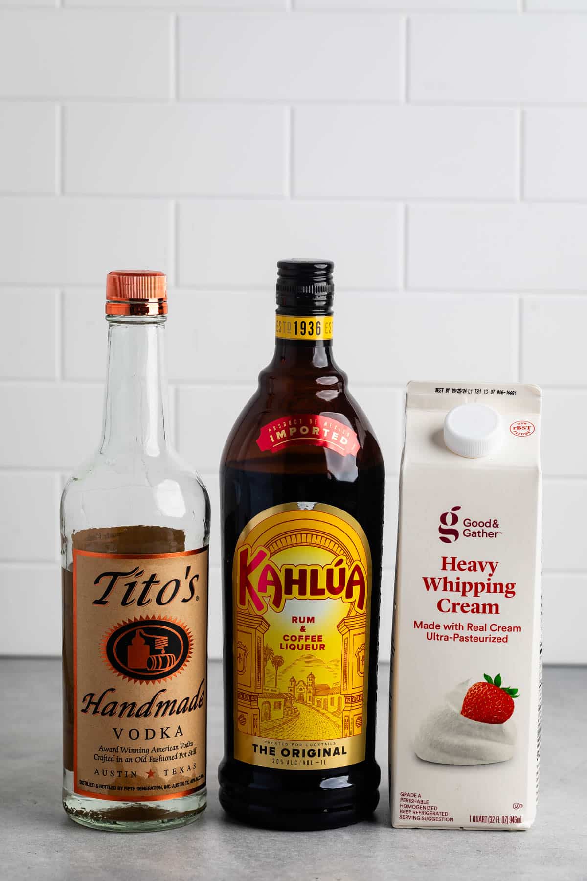 ingredients in the White Russian laid out on a grey counter.