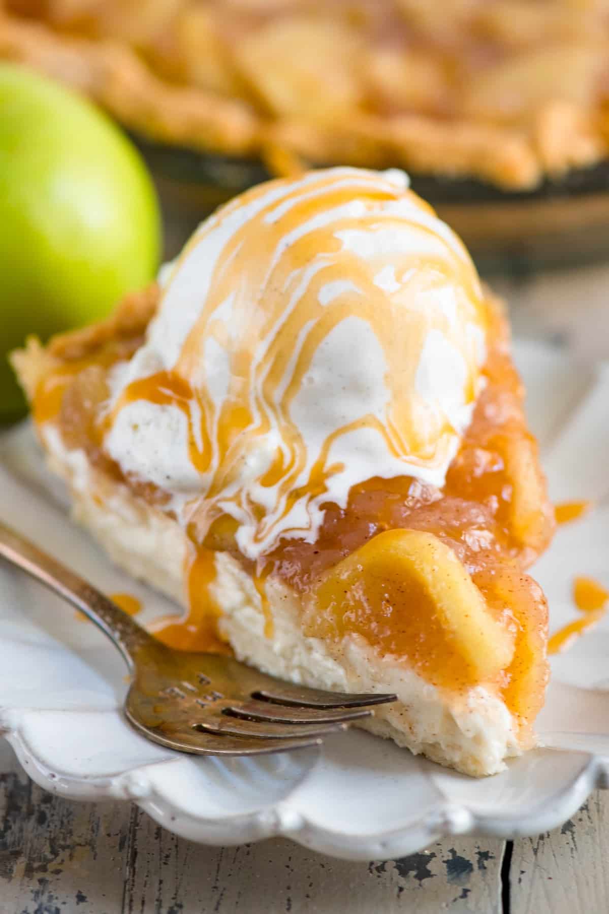 slice of pie with apple and ice cream on top.