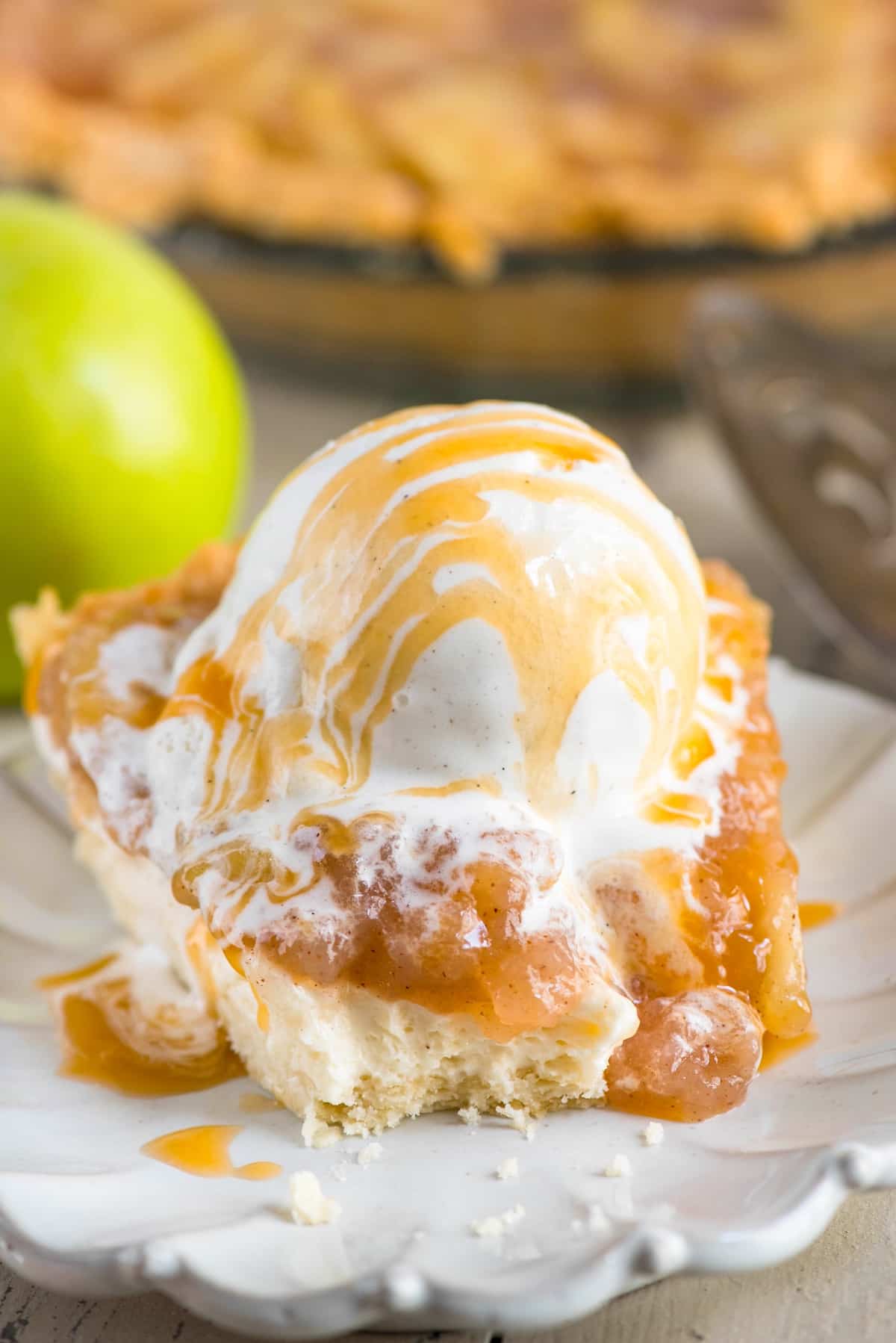 slice of pie with apple and ice cream on top.