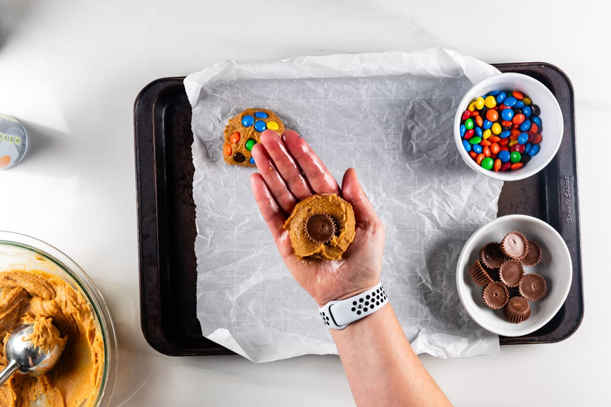 process shot of peanut butter candy cookies being made.