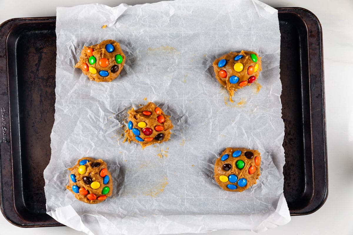 process shot of peanut butter candy cookies being made.