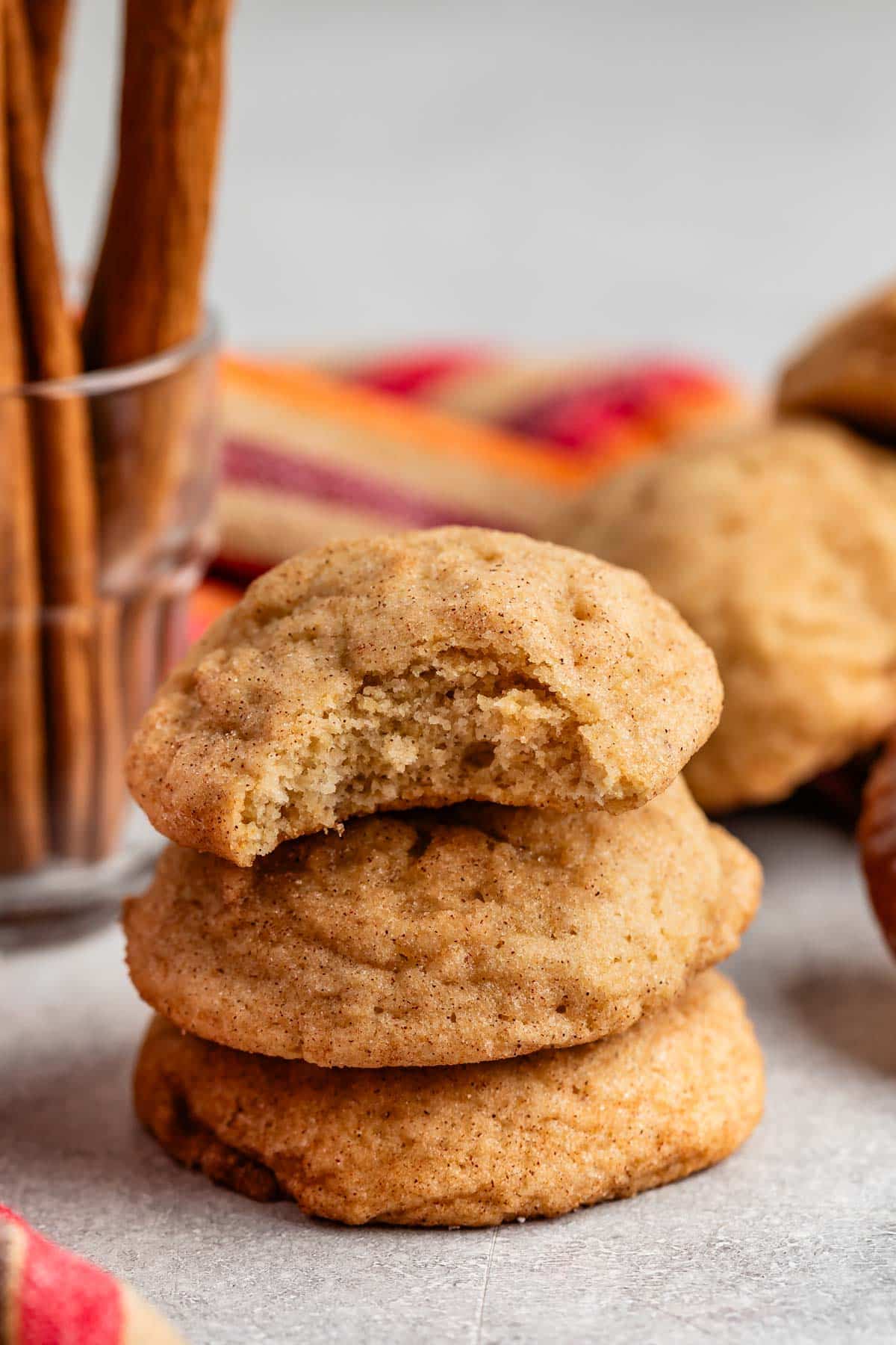 stacked snickerdoodles on a grey surface.