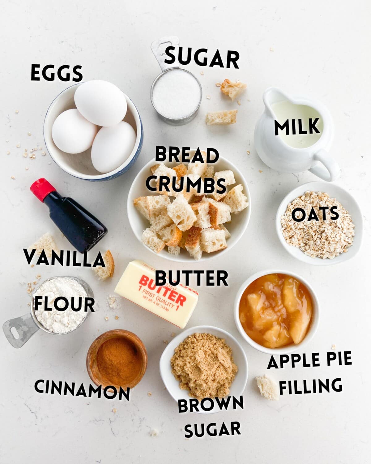 ingredients in an apple casserole laid out on a white counter.