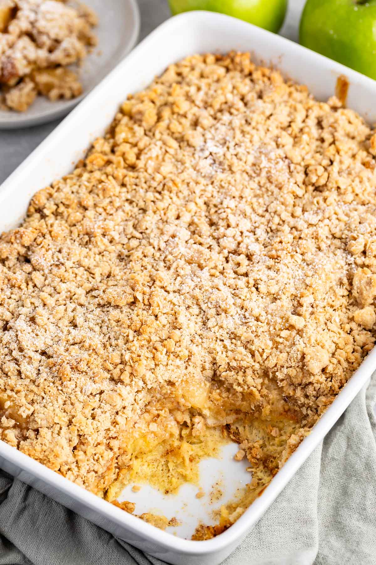 apple pie casserole in a white pan with a crumble on top.