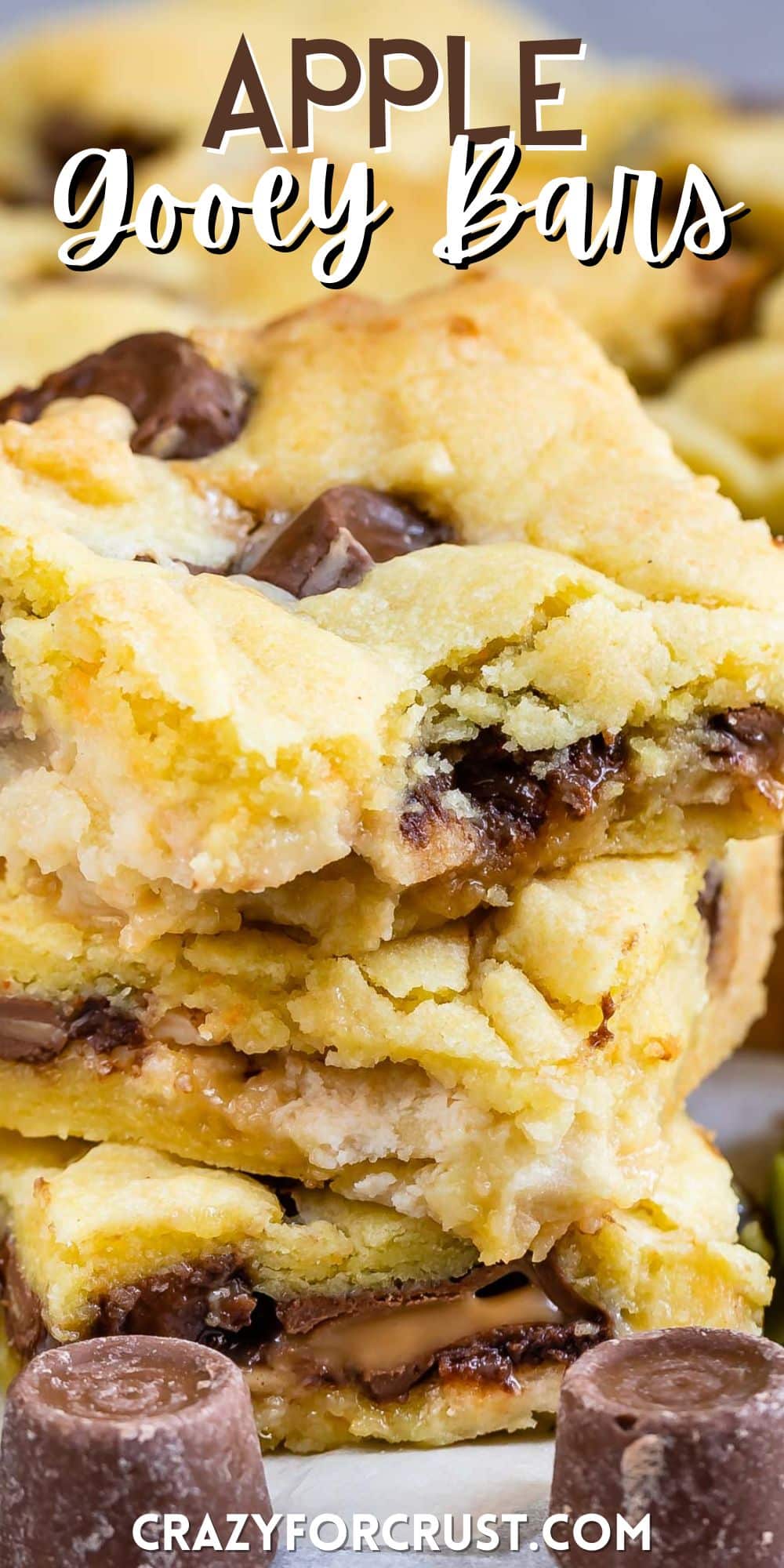 stacked gooey bars with chocolate chips baked in and with words on the image.