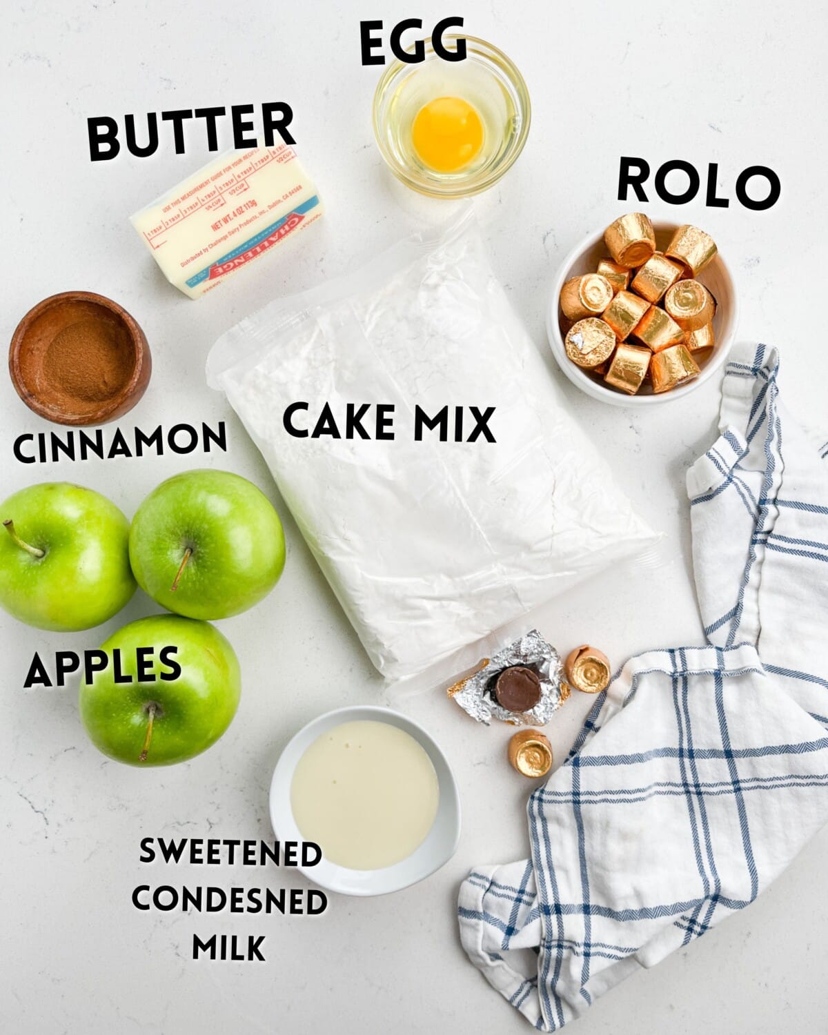 ingredients in apple gooey bars laid out on a white counter.