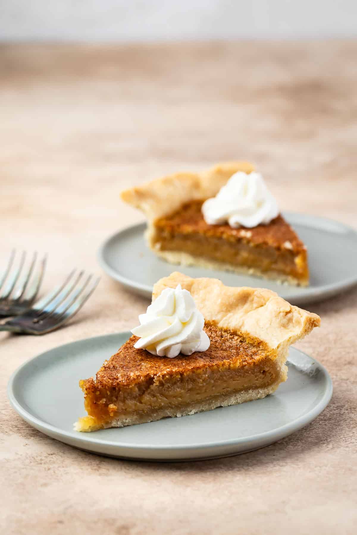 2 slices of pie on gray plates.