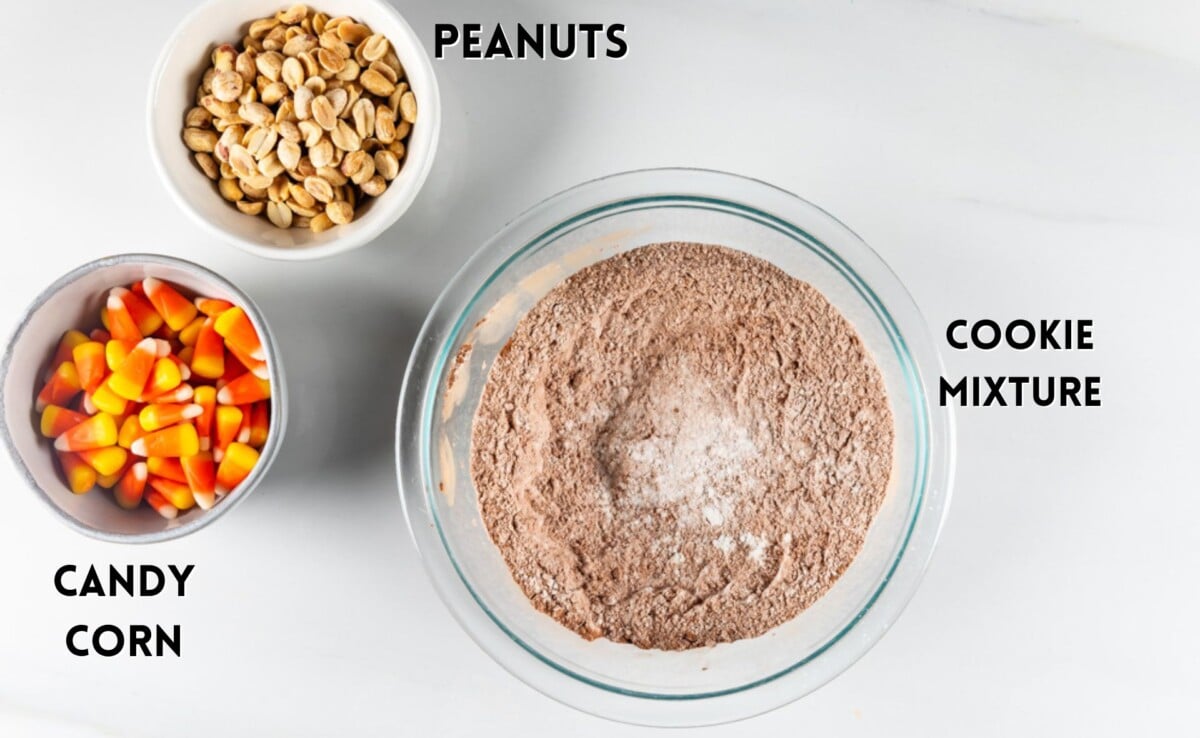 ingredients in candy corn cookies laid out on a white marble counter.