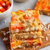 stacked candy corn magic bars with candy corn and coconut baked in.