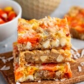 stacked candy corn magic bars with candy corn and coconut baked in.