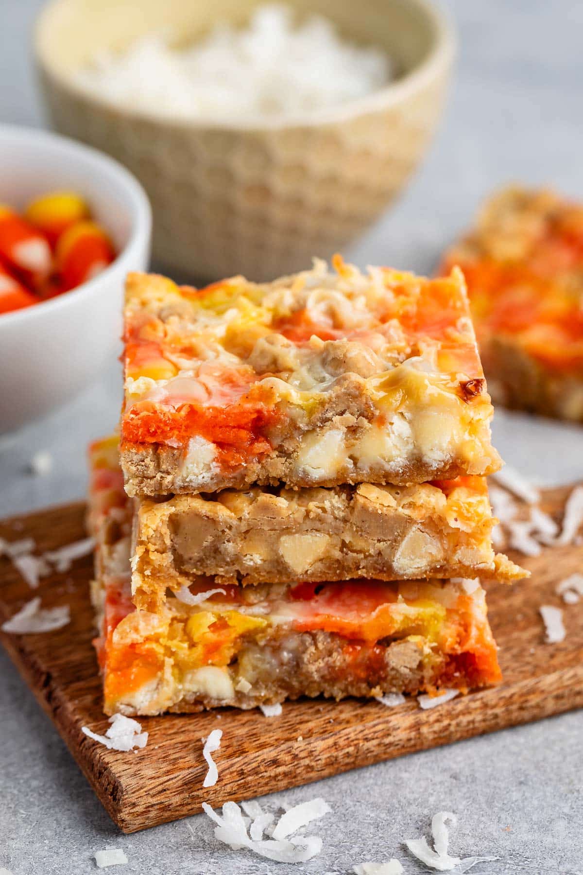 stacked candy corn magic bars with candy corn and coconut baked in.