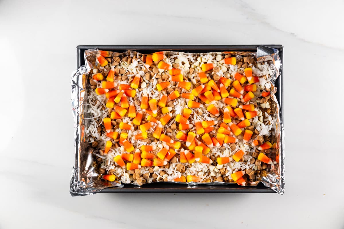 process shot of candy corn magic bars being made.