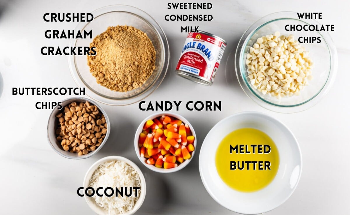 ingredients in candy corn magic bars laid out on a white counter.