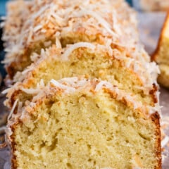 sliced coconut pound cake with toasted coconut on top.