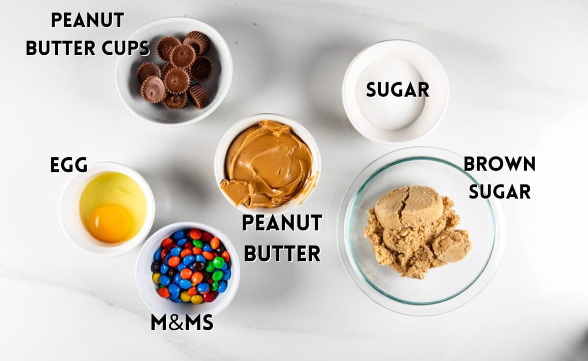 ingredients in peanut butter candy cookies laid out on a white counter.