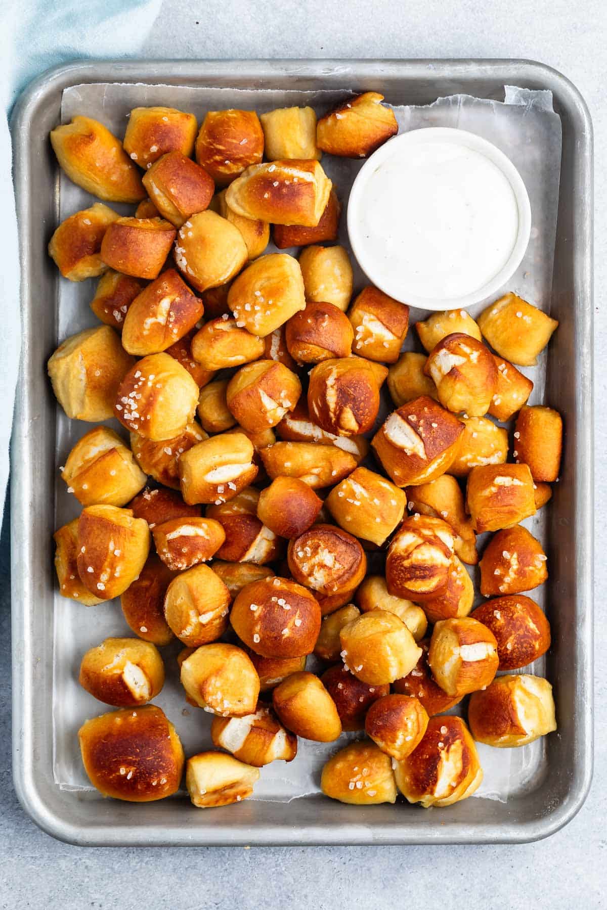 soft pretzel bites piled on top of each other with thick salt on top.