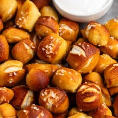 soft pretzel bites piled on top of each other with thick salt on top.