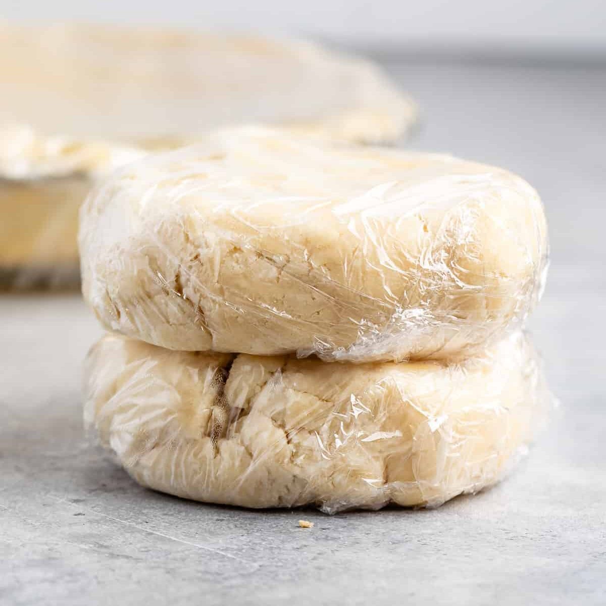 disks of pie dough wrapped in plastic.