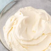 frosting spread across a clear bowl.