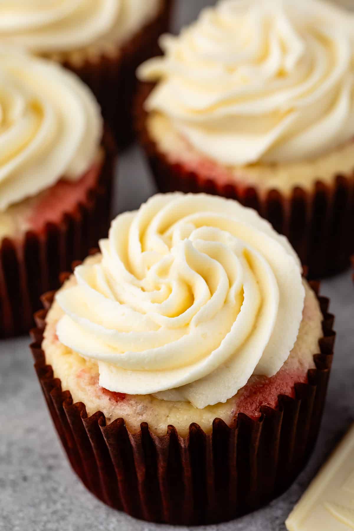 white frosting piped on top of a cupcake.