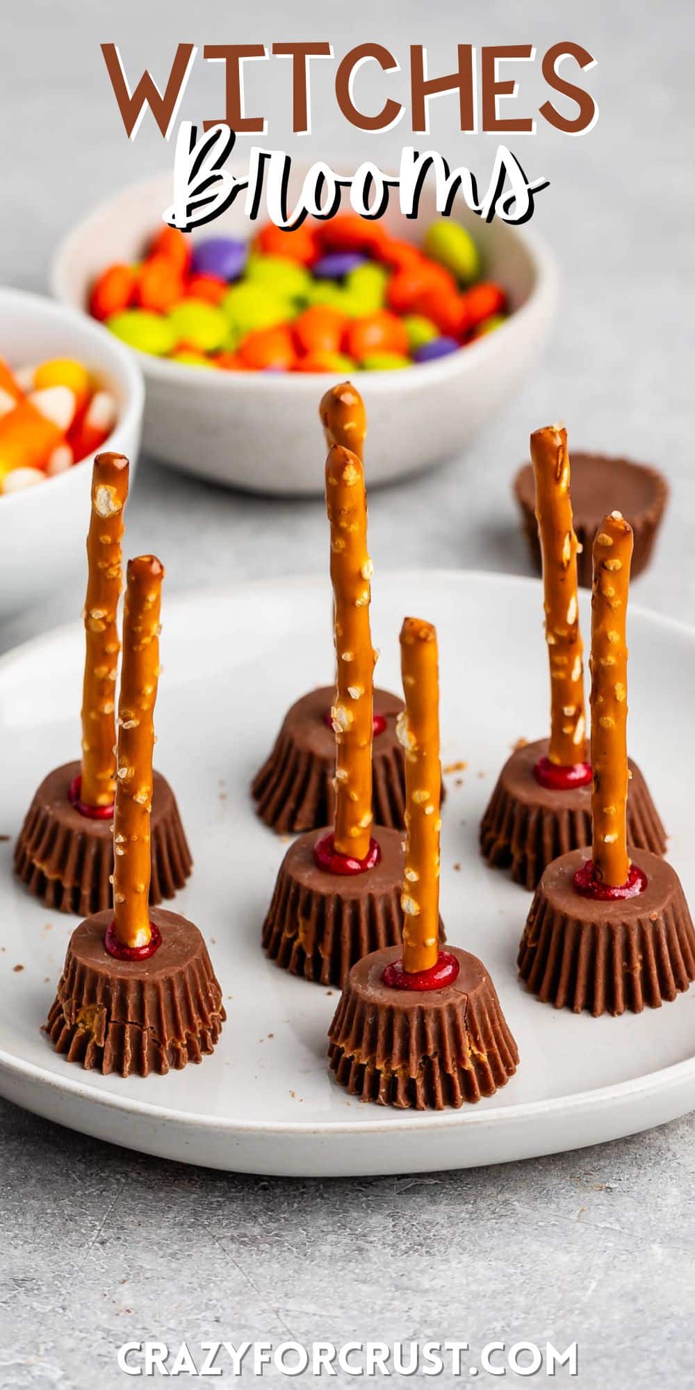 Reeses peanut butter cups with a pretzel stick in the center on a grey plate with words on the image.