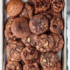 stacked brownie cookies laid on a metal pan.