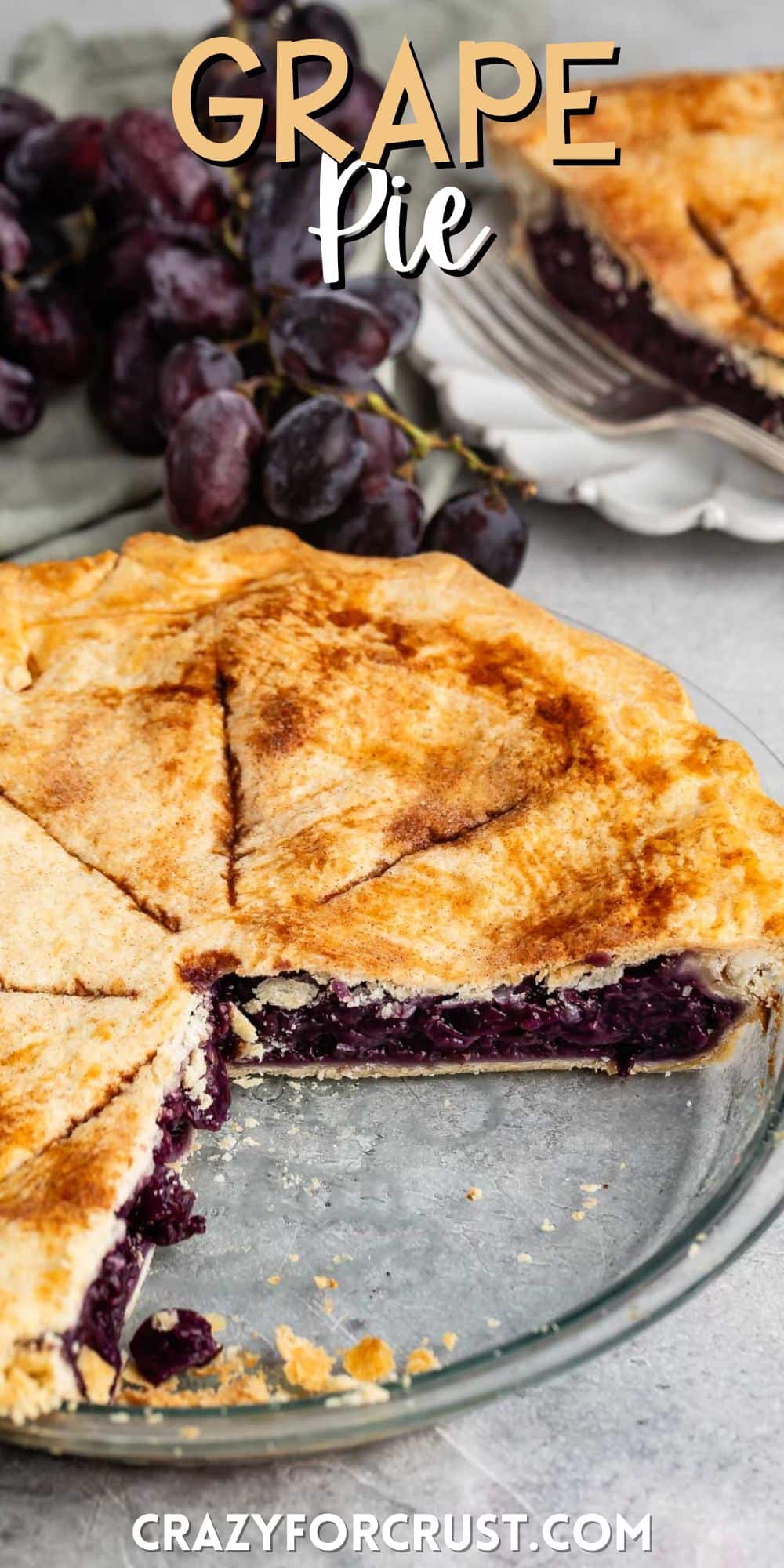 grape pie with purple grape filling in a clear pie pan with words on the image.