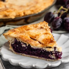 one slice of grape pie with purple grape filling.