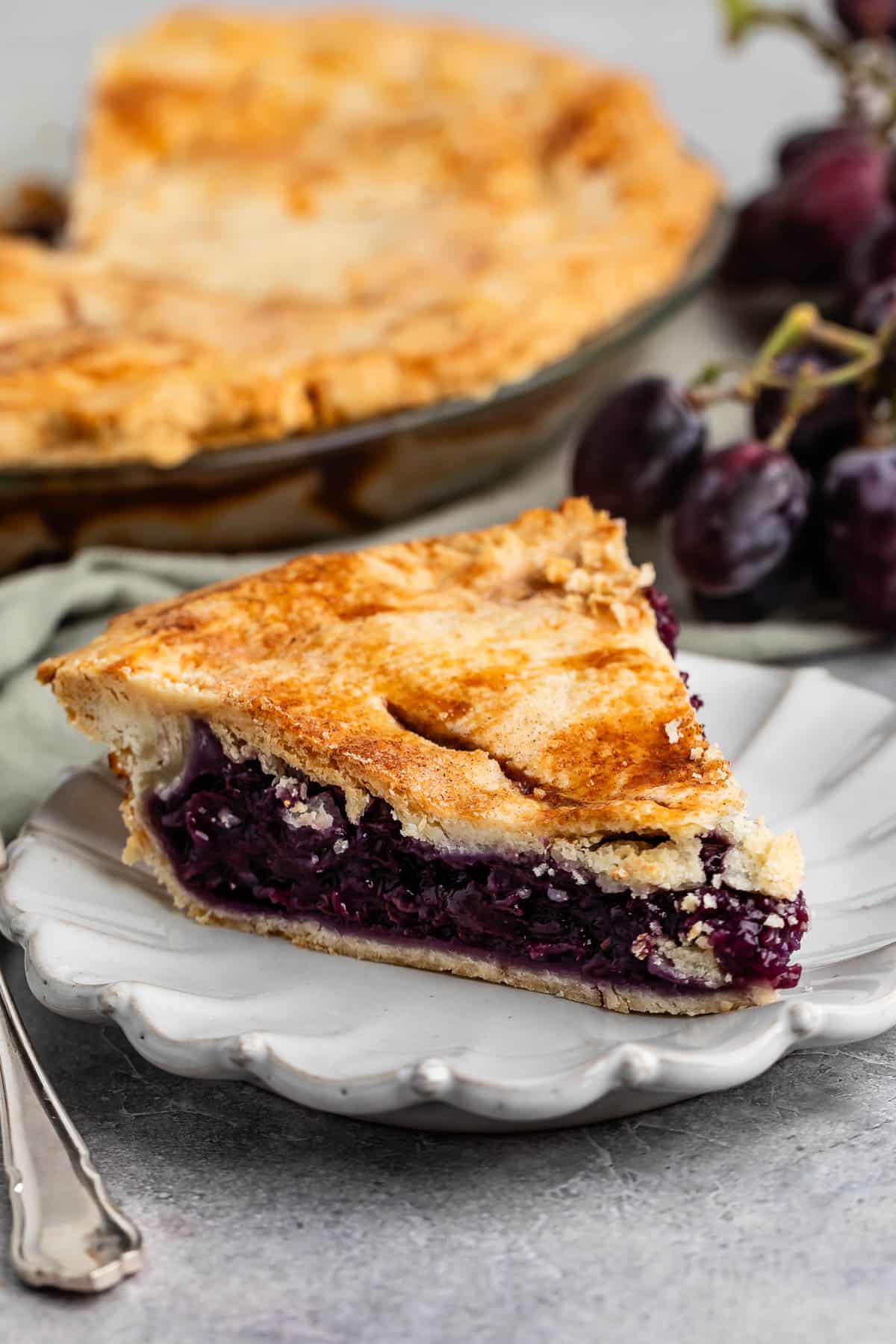 one slice of grape pie with purple grape filling.