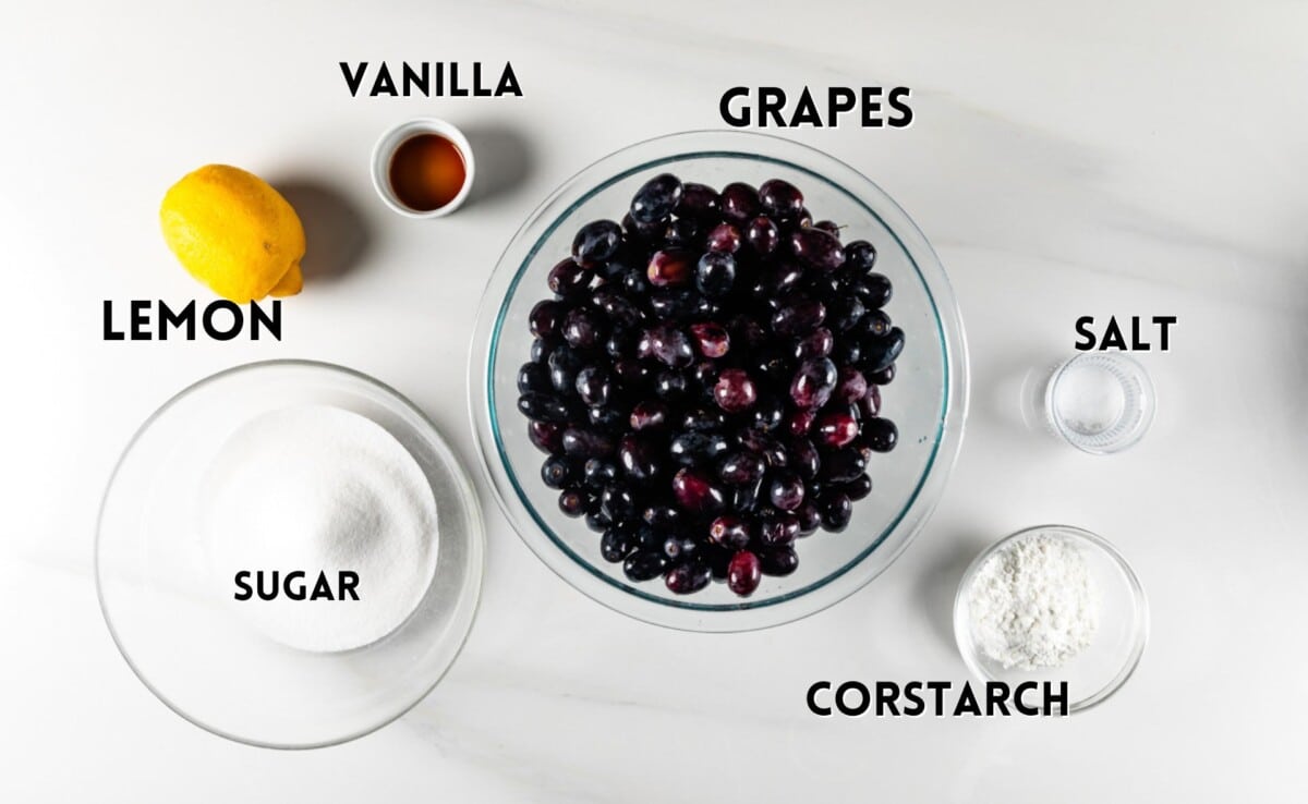 ingredients in grape pie laid out on a white counter.