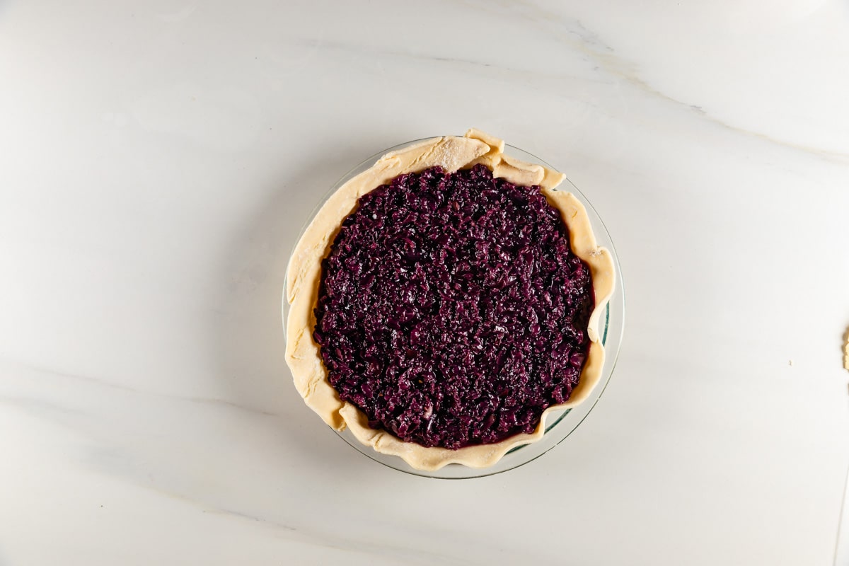 process shot of grape pie being made.